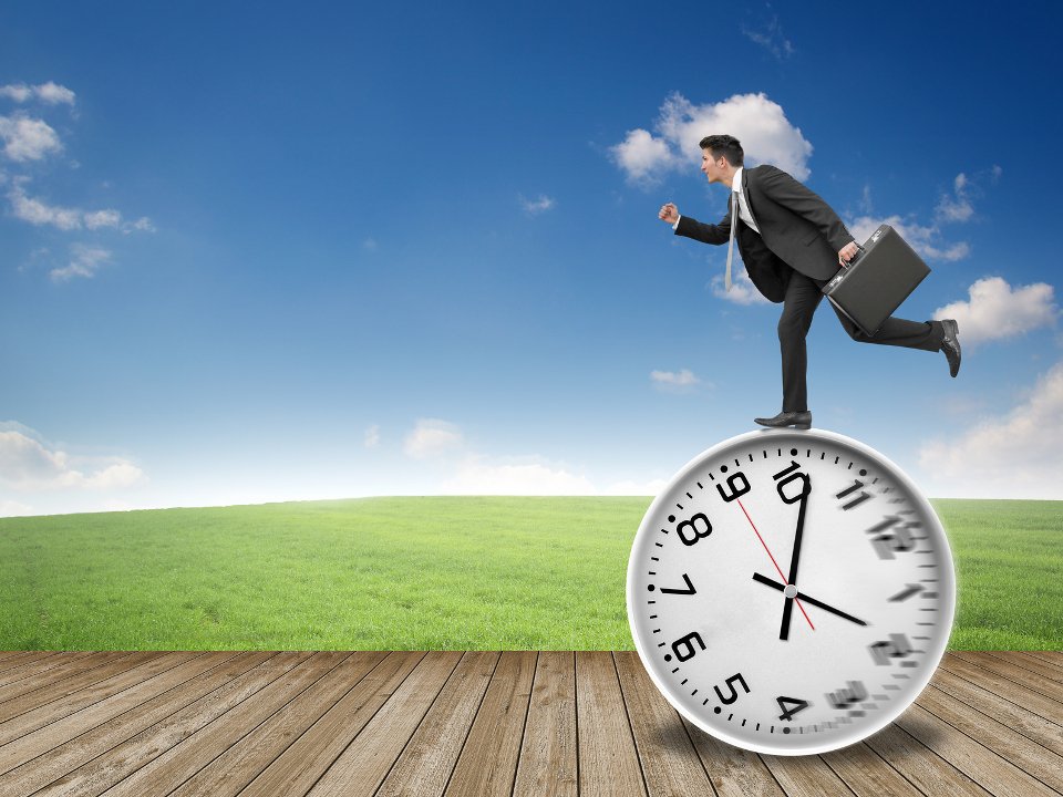  Businessman running on a large clock, symbolizing life time